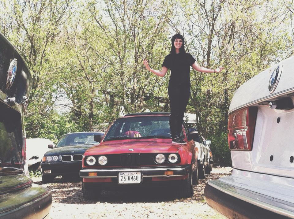 Working in a vintage BMW shop, standing on top of my 325e